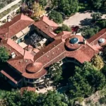 Arnold Schwarzenegger House featuring a luxury estate exterior with elegant architecture, landscaped grounds, and premium design.