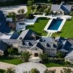 Luxury exterior view of the Joel Osteen home showcasing sophisticated architectural details, manicured gardens, and an impressive modern estate.