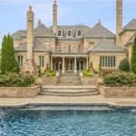 Ja Morant House featuring a modern luxury mansion exterior with elegant architecture, landscaped grounds, and premium real estate styling.