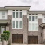 Morgan Wallen House featuring a modern luxury mansion exterior with elegant architecture, landscaped grounds, and premium twilight lighting.